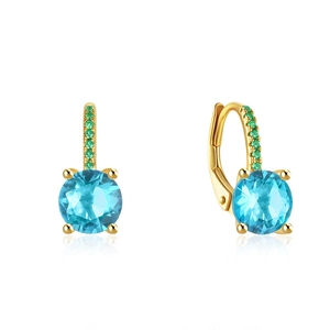 Macro view of gold leverback earrings featuring blue gemstone and green diamond accents