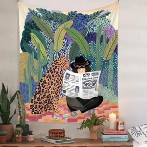 Detail view of Bohemian wall tapestry featuring a leopard and reading woman in tropical forest