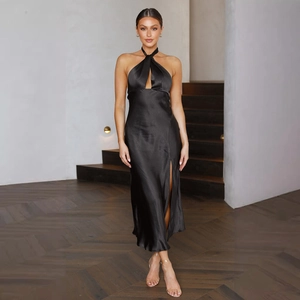 Detail of elegant black satin halter neck dress featuring a high side slit and waist tie