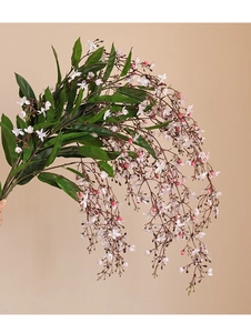 Detail of long artificial jasmine branch with delicate white and pink hanging flowers
