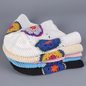 Detail of colorful hand-knitted flower crochet bucket hats in five diverse base colors