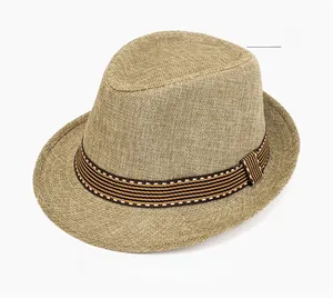 Detail of beige straw jazz fedora with a striped black and yellow decorative ribbon