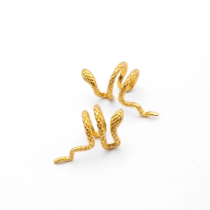 Detailed close-up of double-layered golden snake ear cuff with realistic scale textures