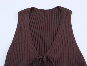 Detail of dark brown rib-knit vest featuring deep V-neckline with lace-up string ties