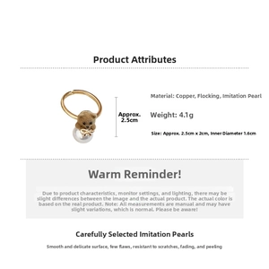 Detail of 18K gold plated ring featuring a flocked bear head and white faux pearl