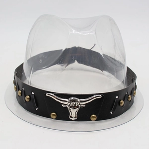Detail of black leather cowboy hat band featuring silver bull head and gold rivets