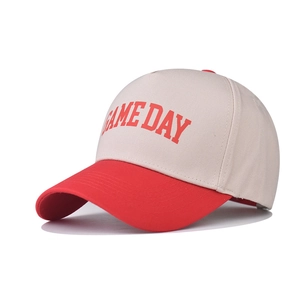 Two-tone GAME DAY baseball cap in beige and red with curved brim on white background