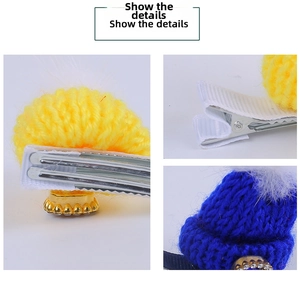 Detail showing blue and yellow knitted Christmas hat hair clips with sequin accents