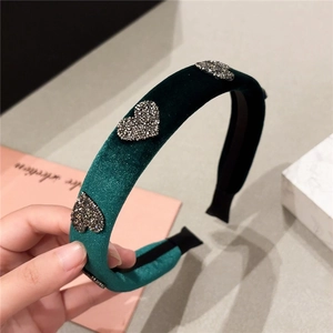 Elegant dark green velvet headband with rhinestone heart detail for a sophisticated look