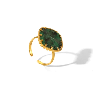 Detail view of gold adjustable ring featuring an irregular green turquoise stone inlay