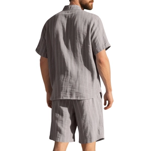 Back view of men's gray striped linen set showing loose fit shirt and beach shorts