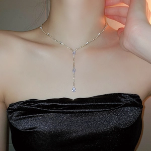 Detail of Y-shaped gold necklace with sparkling water-drop zirconia pendants for women