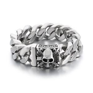 Polished stainless steel skull charm cuban link bracelet for men on white background