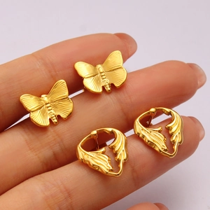 Handheld view of 18K gold plated butterfly studs and hollow leaf earrings set for women