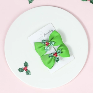 Green ribbon bow hair clips with red berries and glitter leaf detail for girls