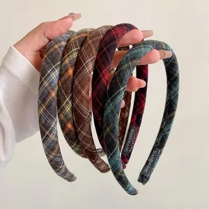 Detail of plaid fabric headbands with handmade labels in retro colors and thick design