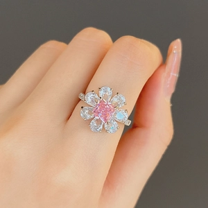 Floral ring with square pink stone and pear zircon petals worn on index finger