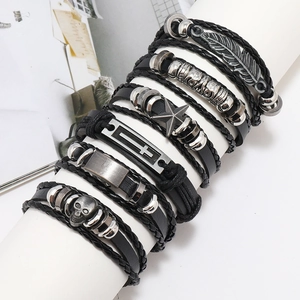 6-piece men's punk leather bracelet set with feather and skull charms on white stand