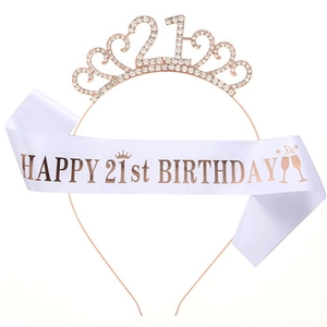 Detailed view of rose gold 21st birthday tiara and white satin happy birthday sash