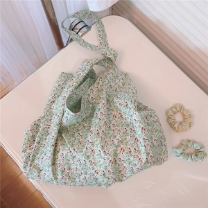 Detailed macro of green floral print cotton tote bag showing fabric texture and strap