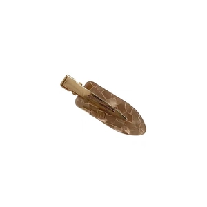 French minimalist brown resin hair clip with geometric texture and golden metal spring