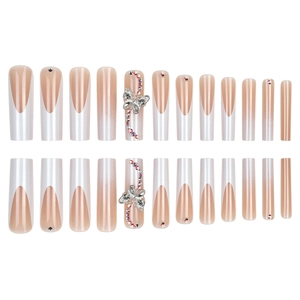 Long trapezoid press-on nails with pink French gradient, 3D bows, and sparkling crystals