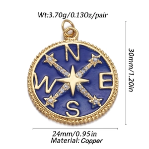 Detailed view of blue enamel compass pendant with gold plating and zircon star details