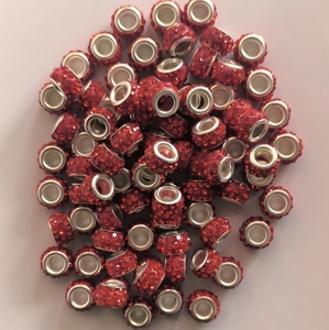Macro shot of 7x12mm sparkling red crystal encrusted polymer clay beads for jewelry making