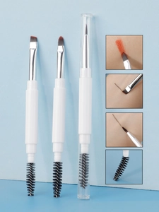 Three dual-ended makeup brushes with soft bristles and caps on a light blue background