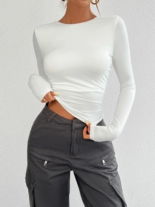 Close-up of white slim fit Y2K knit top with round neck and long sleeves on model