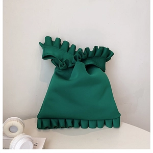 Detail of forest green pleated handbag in soft knit fabric with stylish ruffle edge