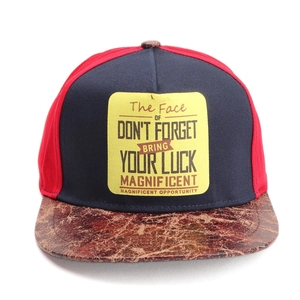 Detail of the brown cracked leather texture on the brim of a two-tone hip-hop baseball cap
