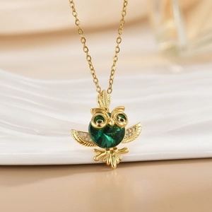 Golden owl pendant necklace featuring green crystal body and micro-paved sparkling zircon wings