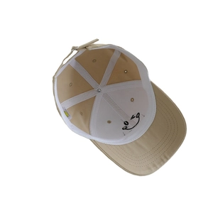 Inside view of beige cotton baseball cap for kids with 6-panel structure and metal buckle