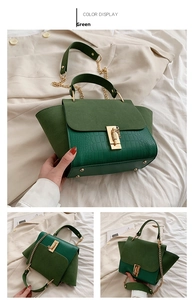 Green vintage wing bag with crocodile texture detail and gold chain buckle hardware