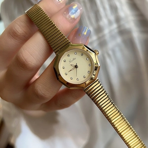 Elegant gold women quartz watch with octagonal bezel and white dial on model wrist