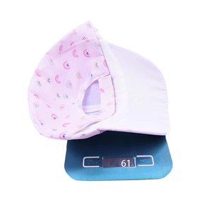 Pink kids baseball cap with rainbow prints on a scale weighing 61g for sun protection