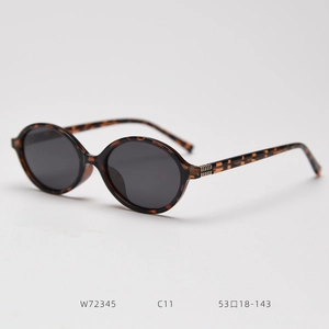 Detail view of tortoiseshell oval sunglasses with dark grey lenses and W72345 model specs