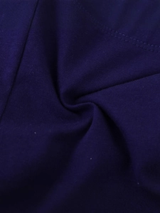 Close-up of soft purple knitted girls leggings showing fine fabric texture and neat stitching