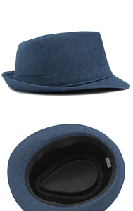 Close-up of blue straw Fedora hat showing woven texture and interior 58cm size tag