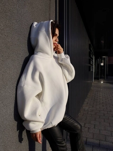 Detailed close-up of white oversized hoodie featuring thick premium cotton fabric texture