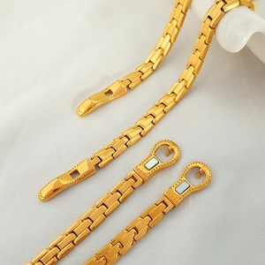 Polished 18K gold stainless steel watch band bracelet with magnetic clasp on white background