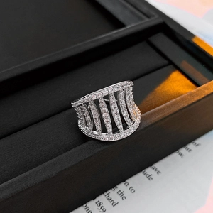 Macro detail of silver hollow out wide ring with sparkling zircon pavé setting