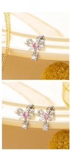 Detail of bow earrings with pink heart zircon and white stone in elegant setup