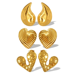 Three pairs of French style gold heart and teardrop earrings in textured stainless steel