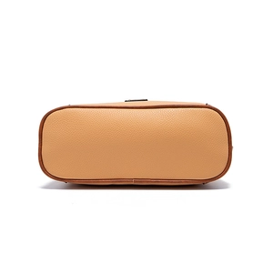 Detail view of lychee texture pebble leather bag base with contrast stitching and edge oil