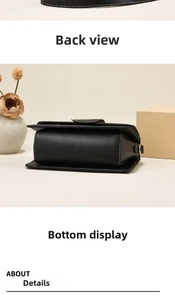 Detail view of black leather crossbody bag with white stitching and gold hardware