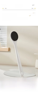 Detail of long-handled lotion applicator with dense black sponge head for easy back skin care