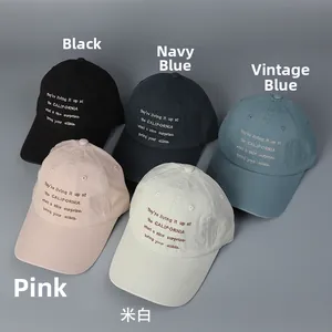 Detail view of five colors of washed cotton baseball caps with California embroidery