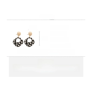 Detail view of retro polka dot acrylic earrings with silver pins and product dimensions
